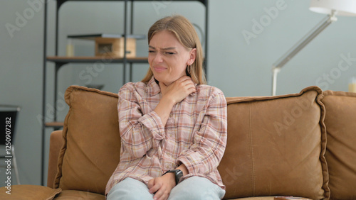 Coughing Young Woman Sitting on Sofa at Home