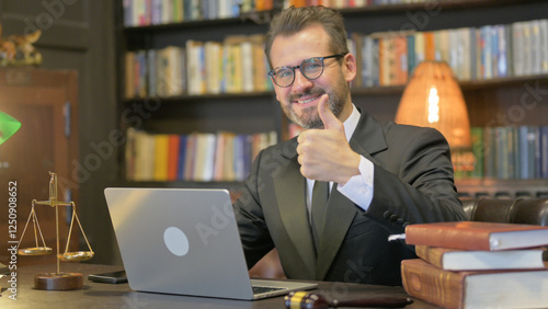 Middle Aged Lawyer with Thumbs Up Working on Laptop