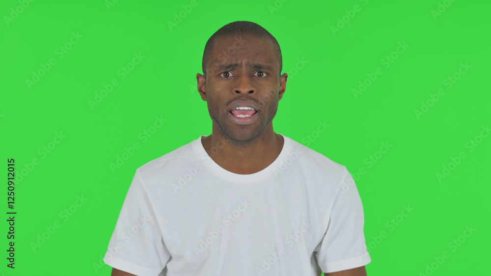 Portrait of Angry African Man Talking in Anger on Green Background Portrait of Angry African Man Talking in Anger on Green Background