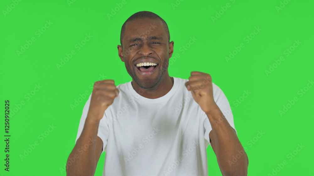 Portrait of African Man Celebrating Success on Green Background Portrait of African Man Celebrating Success on Green Background