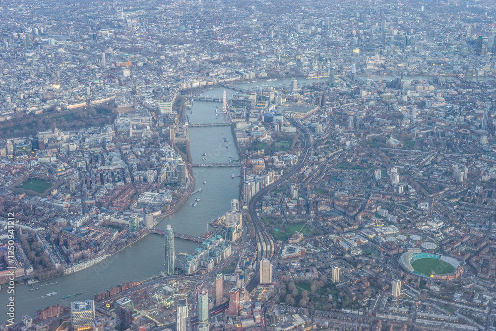 Εκτύπωση καμβά Aerial view of London through early morning clouds with Thames river flowing at