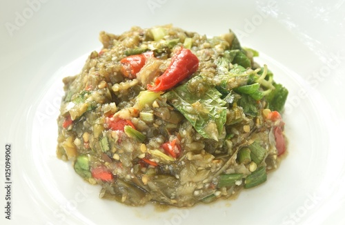 mashed spicy and sour eggplant salad Thai eastern style food on plate photo