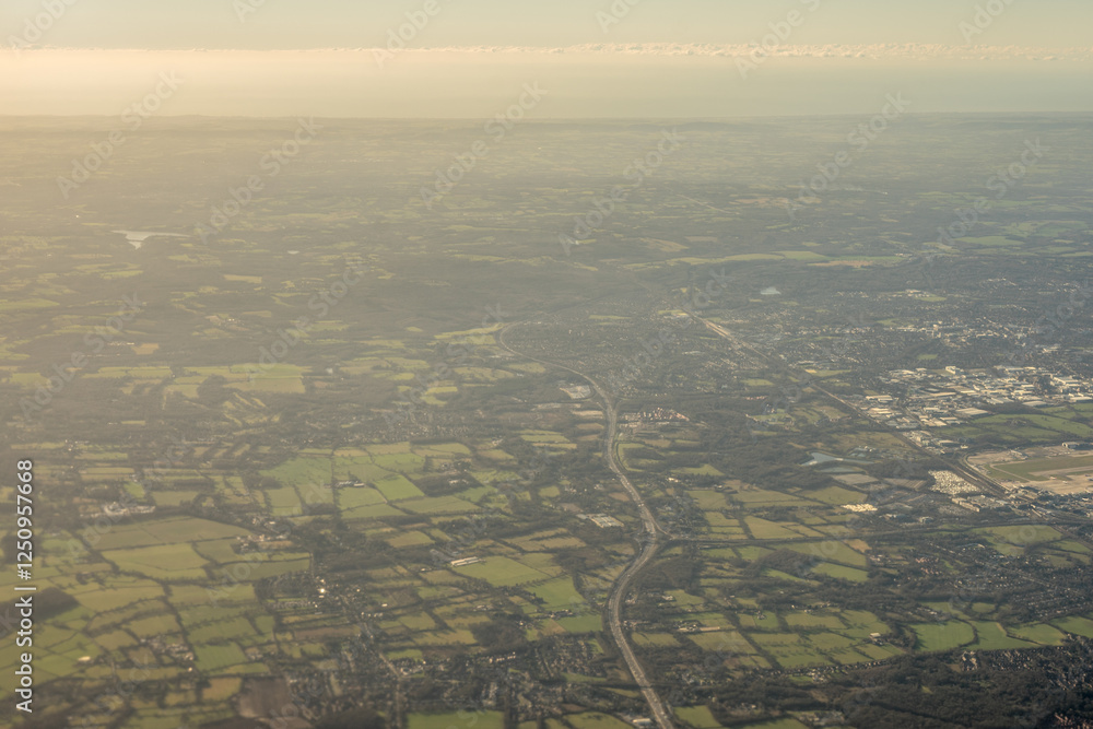 Aerial view of London outskirts suburbs from an aeroplane window