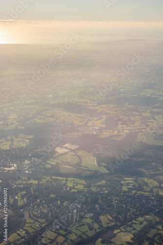 Obraz na płótnie Aerial view of London outskirts lush green fields from an aeroplane window w salonie