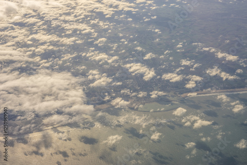 London, United Kingdom, England, a view of the ocean from an aeroplane window with clouds in the sky