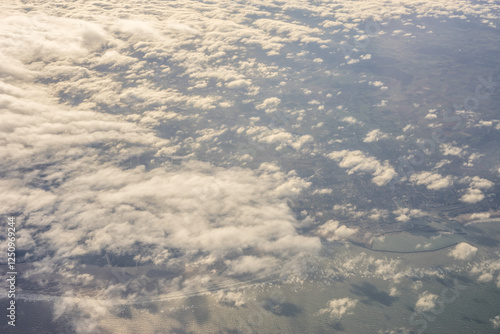 London, United Kingdom, England, a view of the ocean from an aeroplane window with clouds in the sky