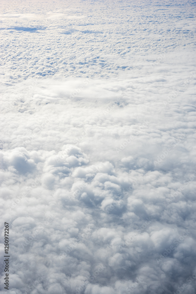 View of clouds from airplane window, clouds in a blue sky