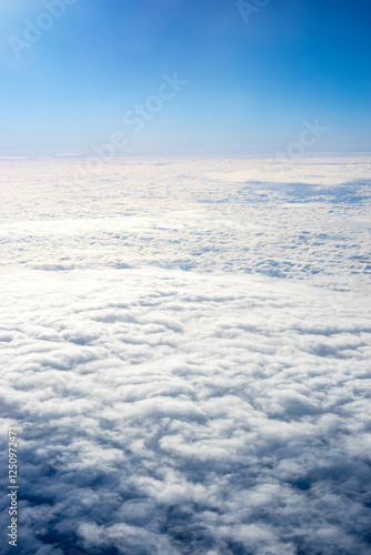 View of clouds from airplane window, clouds in a blue sky