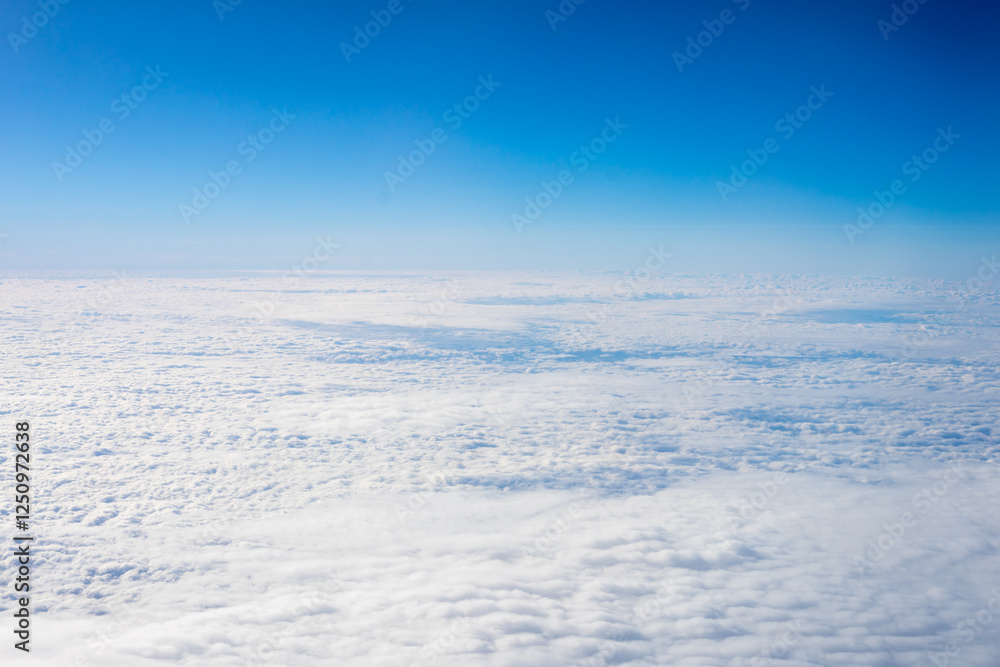 View of clouds from airplane window, clouds in a blue sky
