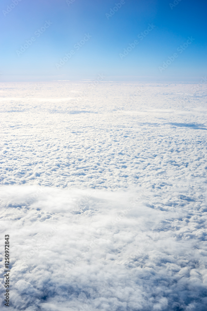 View of clouds from airplane window, clouds in a blue sky View of clouds from airplane window, clouds in a blue sky