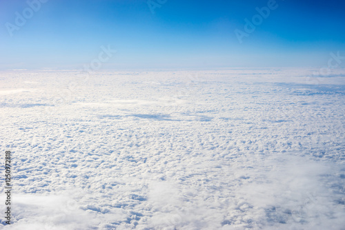 Obraz na płótnie View of clouds from airplane window, clouds in a blue sky w salonie