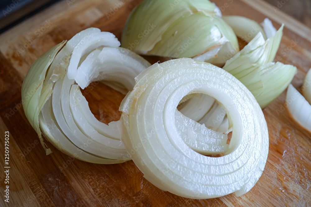 Unfolded onion rings on a cutting board Unfolded onion rings on a cutting board