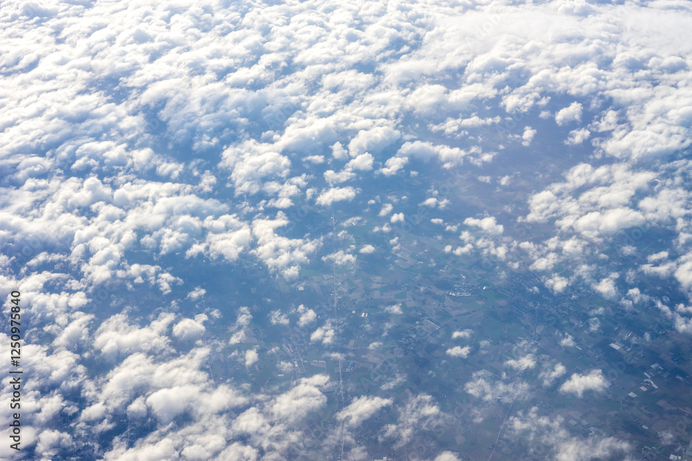 View of clouds from airplane window, clouds in a blue sky