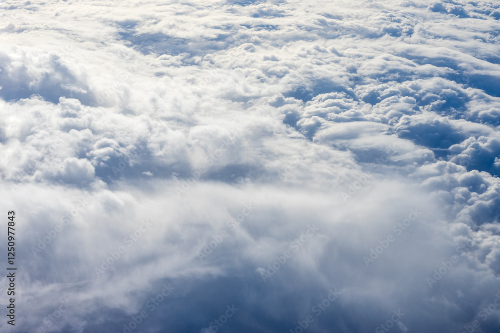View of clouds from airplane window, clouds in a blue sky