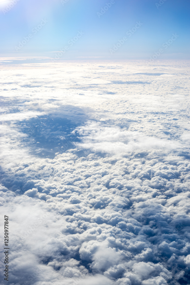 View of clouds from airplane window, clouds in a blue sky