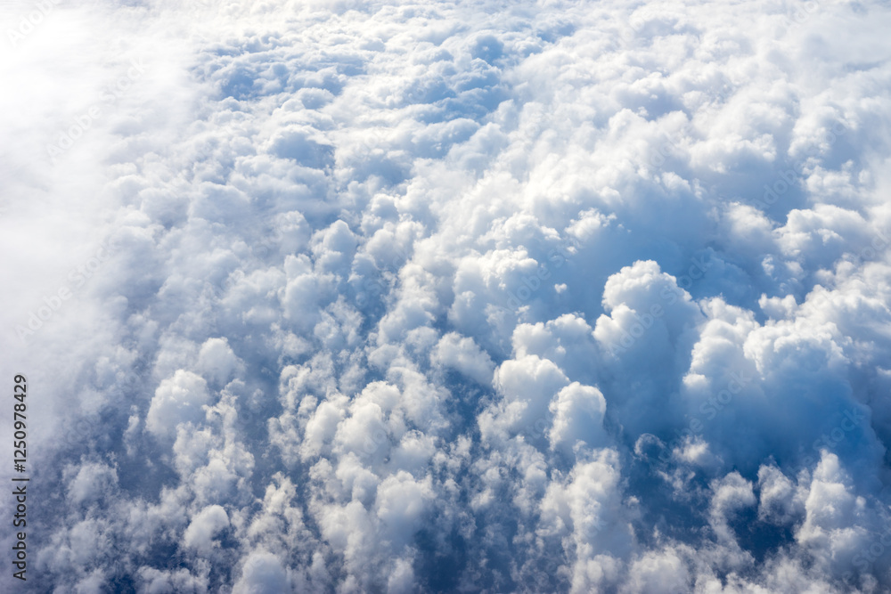 View of clouds from airplane window, clouds in a blue sky