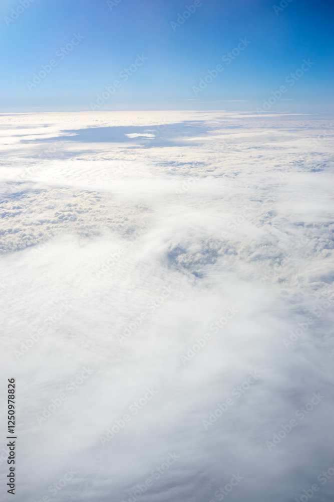 View of clouds from airplane window, clouds in a blue sky