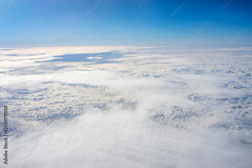 View of clouds from airplane window, clouds in a blue sky