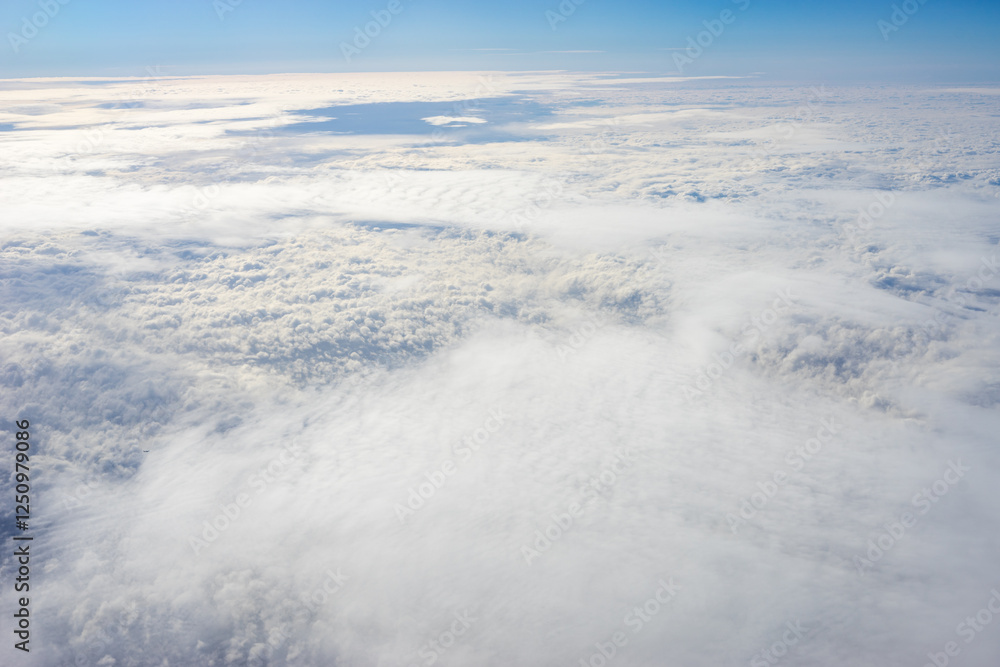 View of clouds from airplane window, clouds in a blue sky