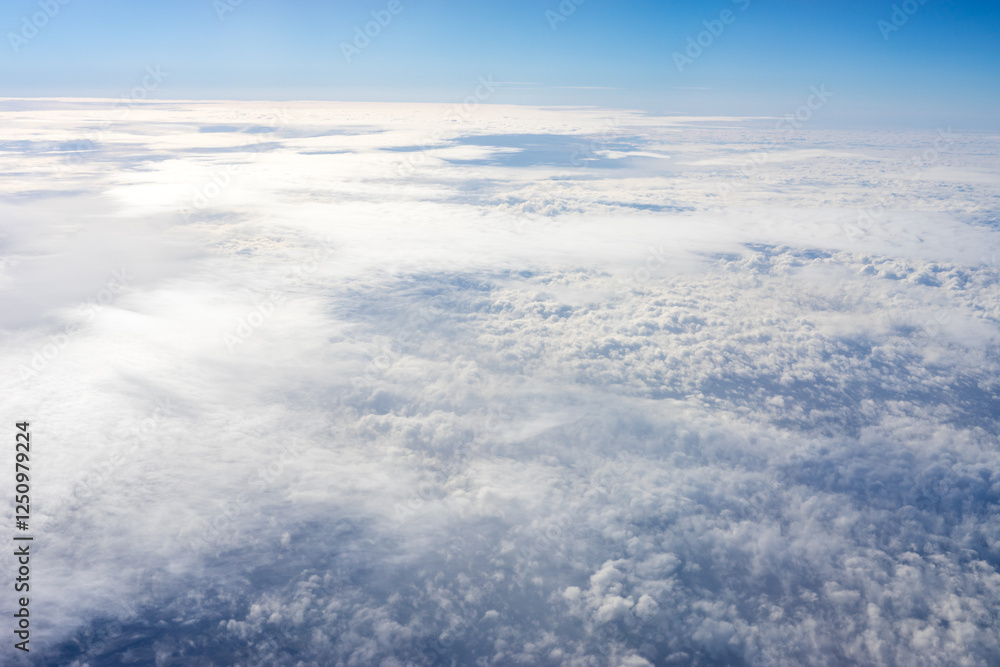 View of clouds from airplane window, clouds in a blue sky