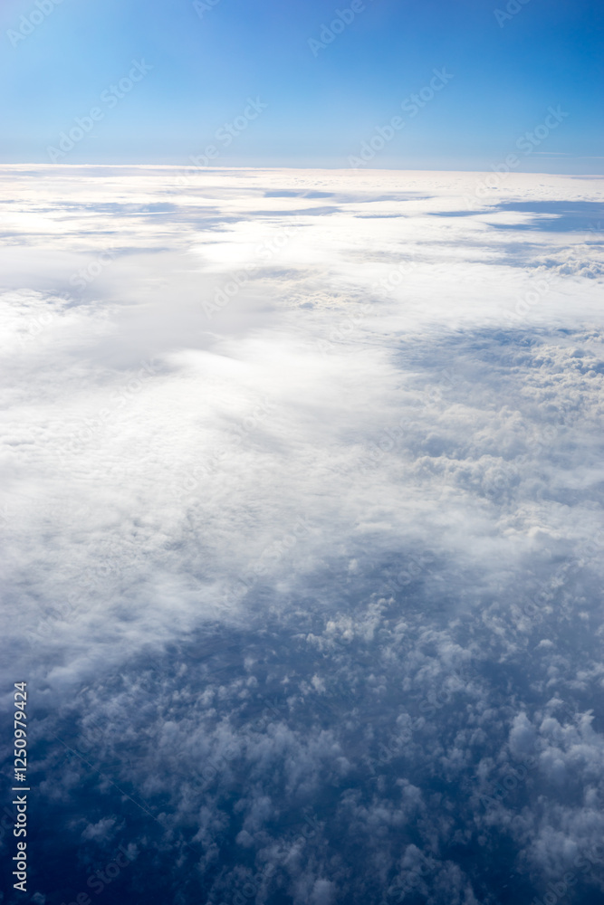View of clouds from airplane window, clouds in a blue sky