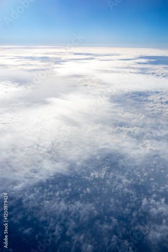 Obraz na płótnie View of clouds from airplane window, clouds in a blue sky w salonie