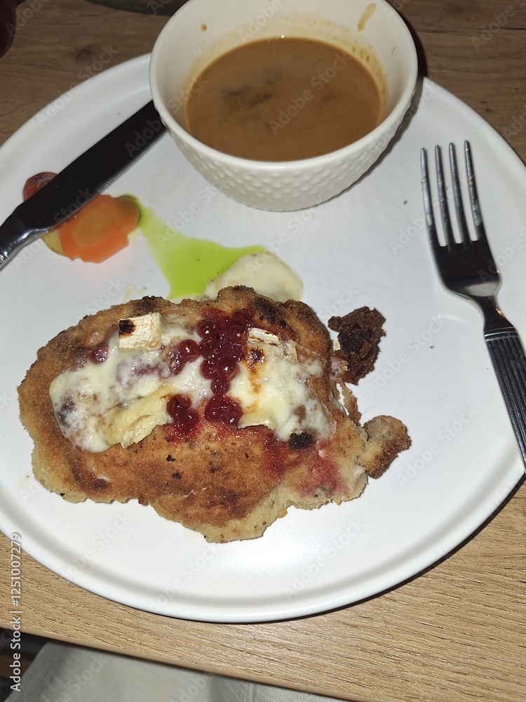 A schnitzel in Germany with cheese A schnitzel in Germany with cheese