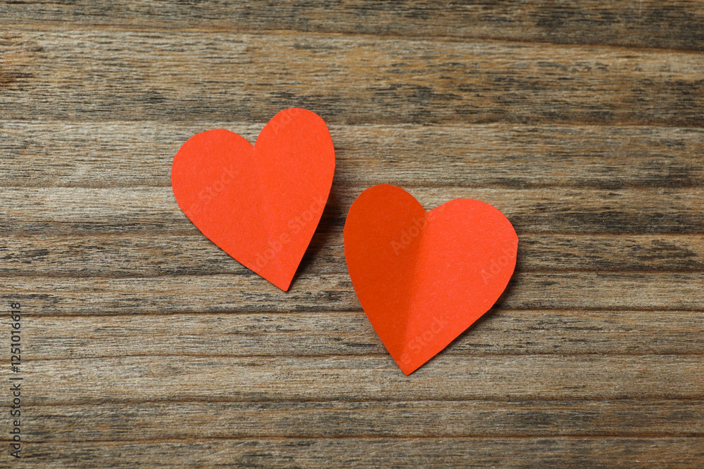 Valentine's Day. Paper hearts on wooden background, top view Valentine's Day. Paper hearts on wooden background, top view