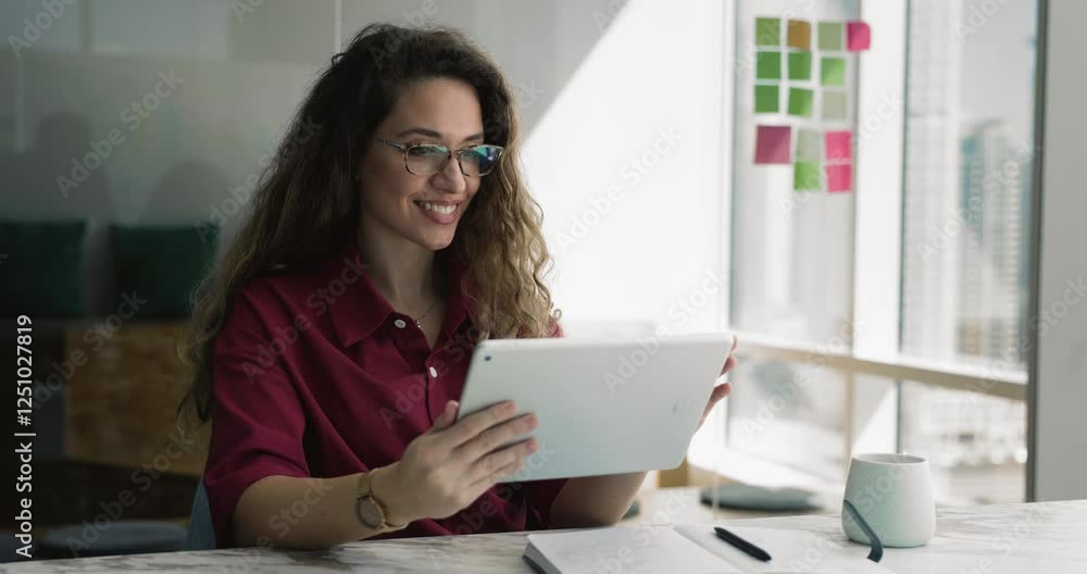 Employee sit at desk using tablet makes important notes in personal organizer, review documents or reports, analyze work-related file, presentations, or project updates, studying or preparing for task Employee sit at desk using tablet makes important notes in personal organizer, review documents or reports, analyze work-related file, presentations, or project updates, studying or preparing for task