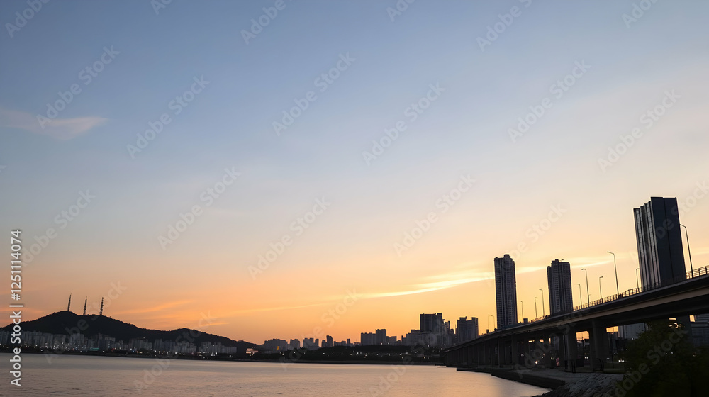 City skyline at sunset over water with bridge, tranquil view City skyline at sunset over water with bridge, tranquil view