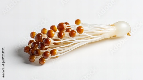 Close-up of a bunch of brown beech mushrooms on a white background. photo