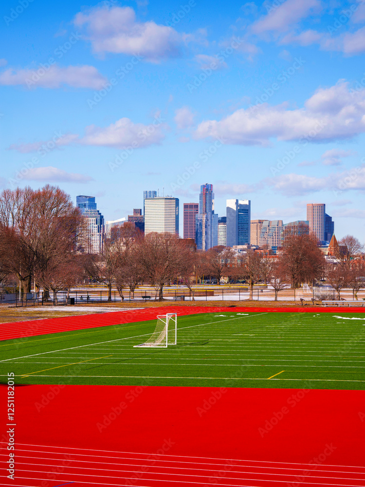 Boston City Skyline over Football Field in Massachusetts, USA: Tranquil winter landscape over the sports arena in New England of America Boston City Skyline over Football Field in Massachusetts, USA: Tranquil winter landscape over the sports arena in New England of America
