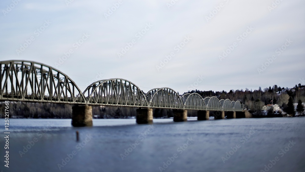 Fototapeta premium The Fetsund Railway Bridge is a historic bridge crossing the Glomma River in Lillestrøm, Norway. Originally built as a wooden bridge in 1860 for the Kongsvinger Line, it was replaced in 1919 by a stee