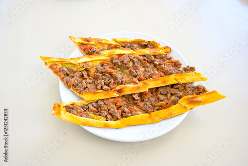 Kiymali pide.Turkish pide with minced meat. Turkish pizza mince pita Pide on white . Etli ekmek.Kusbasi kasarli, kiymali kasarli, kiymali yumurtali, Bafra, Trabzon, Kusbasili pide. Urfa acili lahmacun photo