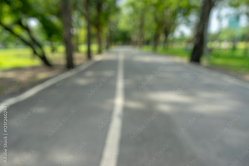 Naklejka premium defocused bokeh background of garden trees in sunny day