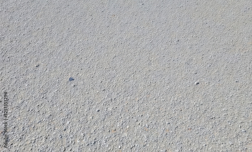 Textured gray surface with small stones Textured gray surface with small stones