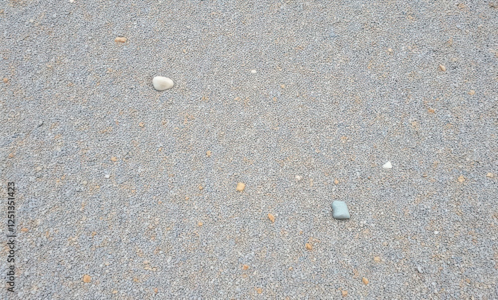 Scattered stones on gravel surface Scattered stones on gravel surface
