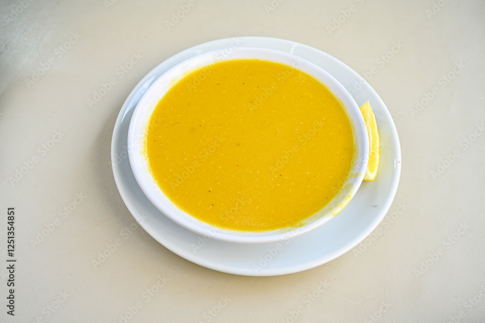 Lentil ( mercimek corbasi ) soup with melted butter and red pepper sauce. Limon ve soslu mercimek corba.