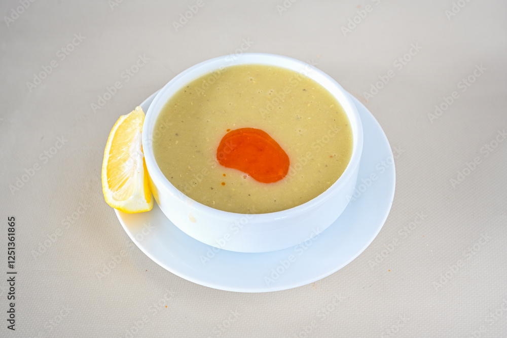 Lentil ( mercimek corbasi ) soup with melted butter and red pepper sauce. Limon ve soslu mercimek corba. Lentil ( mercimek corbasi ) soup with melted butter and red pepper sauce. Limon ve soslu mercimek corba.