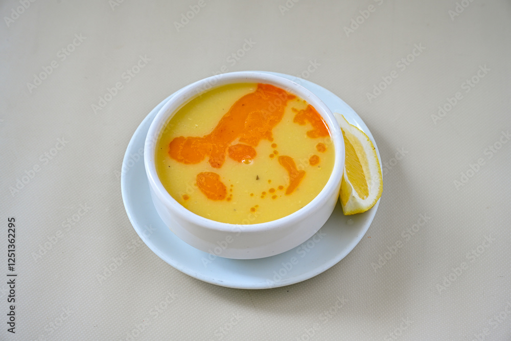 Lentil ( mercimek corbasi ) soup with melted butter and red pepper sauce. Limon ve soslu mercimek corba. Lentil ( mercimek corbasi ) soup with melted butter and red pepper sauce. Limon ve soslu mercimek corba.