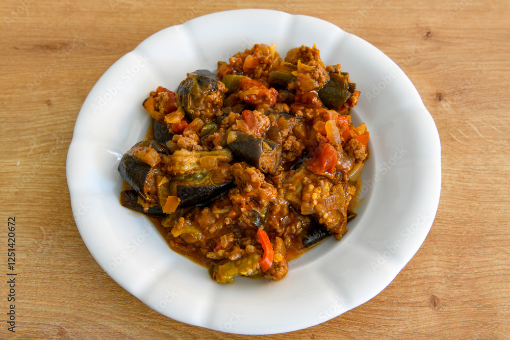 Meat with eggplant and pepper.Cooked with vegetables and hot spices. Patlican kebab, musakka. Meat with eggplant and pepper.Cooked with vegetables and hot spices. Patlican kebab, musakka.