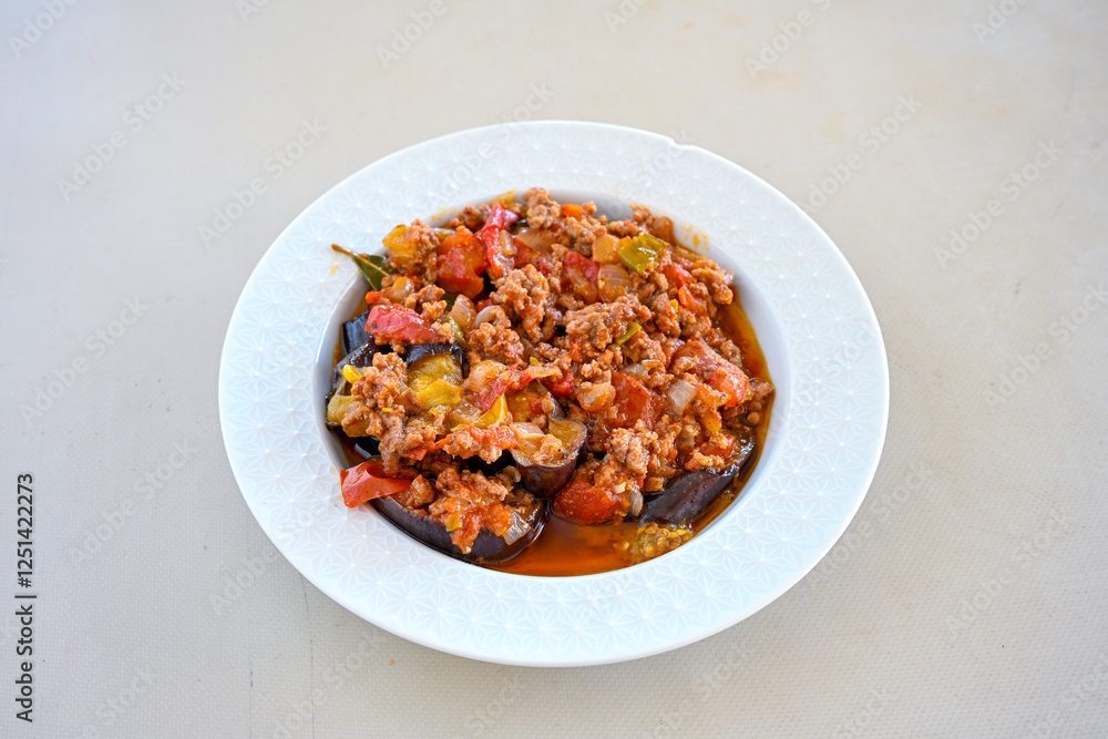 Meat with eggplant and pepper.Cooked with vegetables and hot spices. Patlican kebab, musakka. Meat with eggplant and pepper.Cooked with vegetables and hot spices. Patlican kebab, musakka.