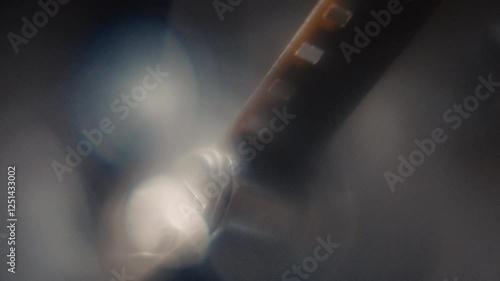 Close ups of a vintage 8MM projector spools moving and playing film 