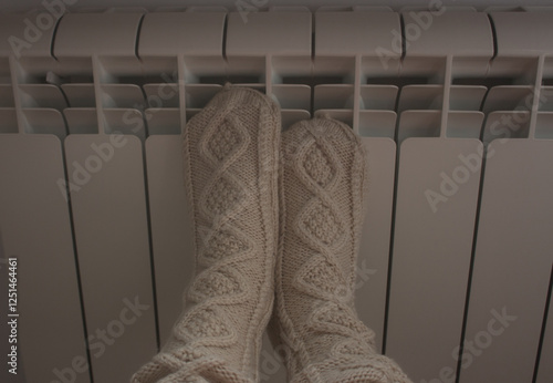 Warm your feet in warm socks on the radiator
