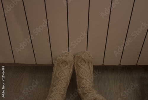 Warm your feet in warm socks on the radiator

