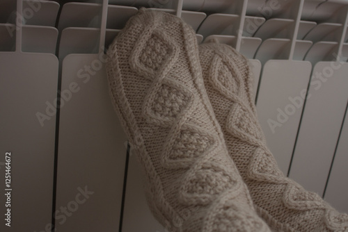Warm your feet in warm socks on the radiator
