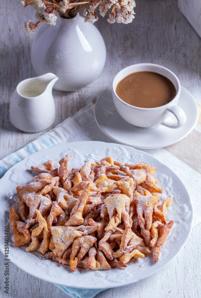 Traditional Maslenitsa dessert angel wings served with coffee on a light background.