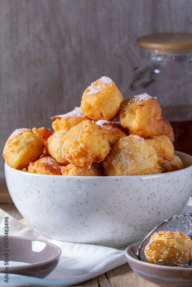 Curd donuts with sugar served with tea or coffee on a light wooden background. Rustic style.