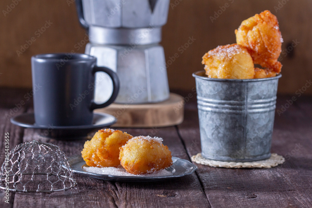 Curd donuts with sugar served with tea or coffee on a light wooden background. Rustic style.