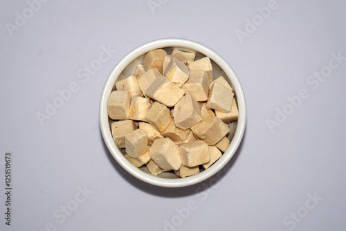 a bowl of freeze dried chicken breast in cube for cat and dog